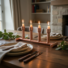 Laden Sie das Bild in den Galerie-Viewer, Copper candle holder with lit candles on a dining table with plates and cutlery.