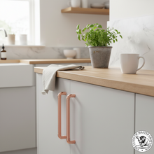 Load image into Gallery viewer, Copper cupboard door handles in light grey kitchen
