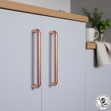 Load image into Gallery viewer, Copper cupboard door handles in light grey kitchen
