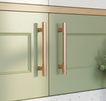 Load image into Gallery viewer, Green cabinet with satin copper handles in a kitchen setting