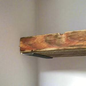 Alcove angled iron bracket for discreet alcove shelving showing a rustic wooden shelf.