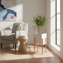 Load image into Gallery viewer, Modern living room with a gray armchair, wooden side table, and plant in a white pot.