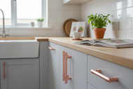 Kitchen with light gray cabinets, wooden countertops, and copper handles.