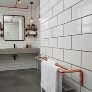 Modern bathroom with white tiled walls, a concrete vanity, and copper towel rack.