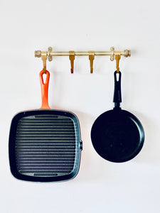 Brass Heavy Duty Kitchen Utensil Rail With Five Brass Hooks Holding Cast Iron Skillet And Frying Pan