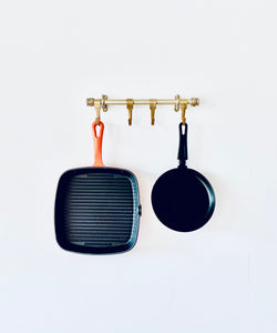 Brass Heavy Duty Kitchen Utensil Rail With Five Brass Hooks Holding Cast Iron Skillet And Frying Pan