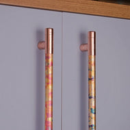 Antique copper T bar handles on a cabinet.